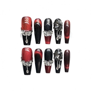 Dark red cat eye press-on nails with rhinestone accents and coffin shape design