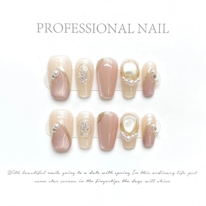 Handmade pearlescent cat eye press-on nails with golden French tips and pearl accents