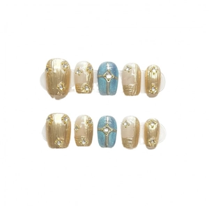 Handmade press-on nails with blue glitter, champagne gold finish and rhinestone accents