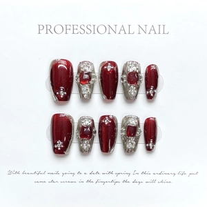 Macro detail of wine red handmade press-on nails with silver liquid metal and rhinestones