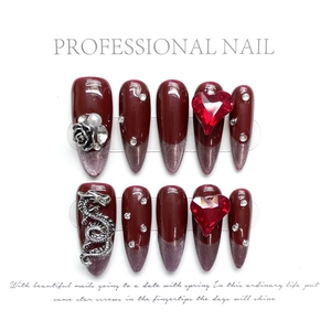 Burgundy cat eye press-on nails with silver dragon and red heart crystal charms