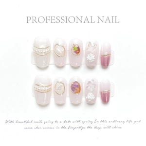 Detail of pink and white press-on nails with 3D white butterflies and pearl accents