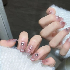 Pink cat eye press-on nails with silver butterfly charms and 3D embossed bubble details