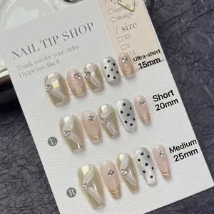 Champagne gold and black polka dot press-on nails in three coffin lengths from 15mm to 25mm