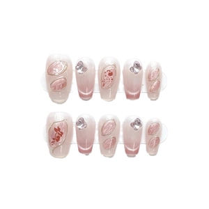 Handmade cat-eye press-on nails in pink gradient with butterfly charms and gold details