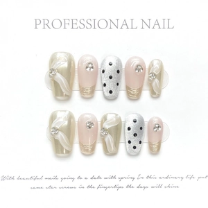 Elegant champagne gold bow and polka dot press-on nails set on white background