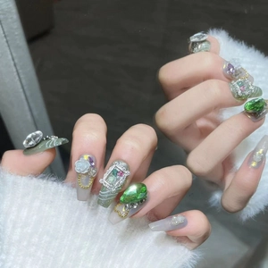 Luxurious olive green handmade press-on nails with 3D emerald gems and floral reliefs