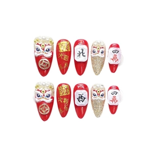 3D embossed lion dance press-on nails in red and gold with mahjong and fortune charms