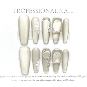 Champagne cat eye press-on nails with 3D crystal gems and white floral accents