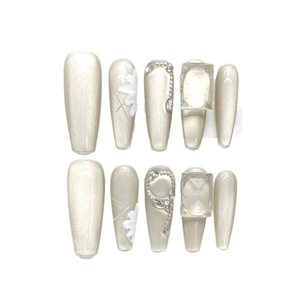 Champagne cat eye press-on nails with 3D white floral design and pearl rhinestones