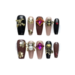 Gothic 3D press-on nails with skull, spider charms and pink gemstones in black and nude