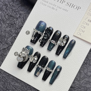Handmade press-on nails with dark green cat-eye effect and 3D dragon and lion head charms