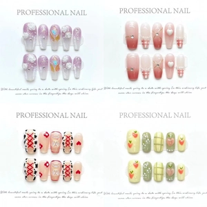 Assorted handmade long coffin press-on nails featuring cat-eye, floral, and bear designs