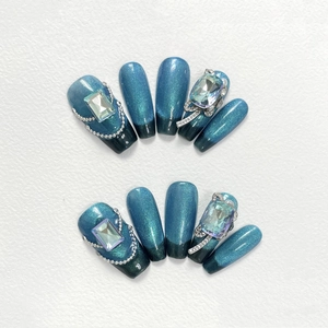 Handmade blue cat-eye press-on nails with luxury rhinestones and black gradient