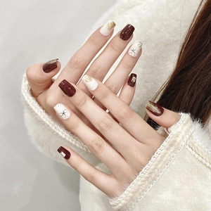 Short square press-on nails in cream and burgundy with floral art and gold accents