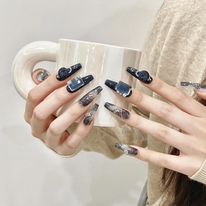 Handmade coffin press-on nails with blue galaxy marble art and 3D gemstone accents