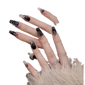 Faux ongles gothiques avec breloques araignée, gemmes noires et motifs croix sur ongles longs