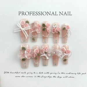Detail of handmade press-on nails featuring 3D pink roses, pearls and white bow accents