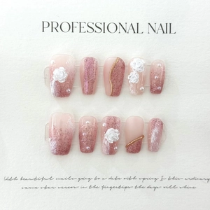 Detailed view of handmade press-on nails with 3D roses, pearls and rose gold glitter