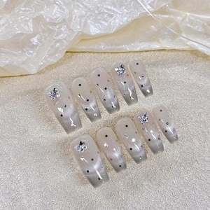 Gray cat-eye press-on nails with silver glitter and 3D crystal butterfly accents