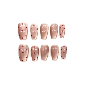 Pink cat eye press-on nails with red polka dots in medium-long coffin shape