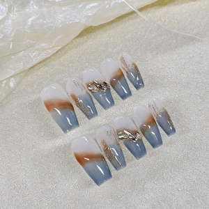 Handmade coffin nails featuring blue-grey gradient and gold metallic sculptural details