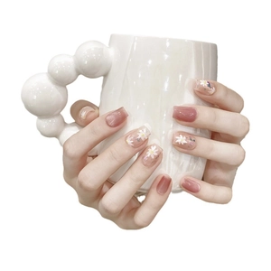 Short square cat-eye press-on nails with white daisy floral design on hands