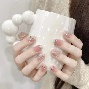 Pink gradient square press-on nails with silver bows and sparkling rhinestones