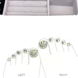 Sparkling champagne gold press-on toe nails with crystal rhinestones on white base