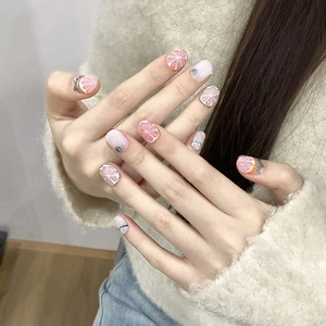 Handmade grapefruit citrus press-on nails in soft pink and creamy white tones