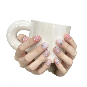 Handmade press-on nails featuring creative grapefruit and lemon citrus fruit art designs