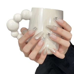 Cat eye press-on nails with rhinestones and pearls on long coffin shaped tips