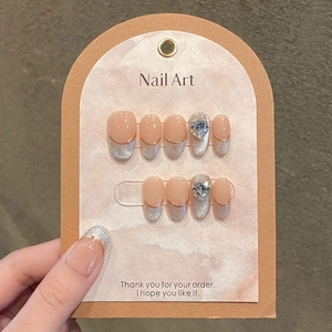 Handmade cat-eye press-on nails with silver French tips and heart crystal accents