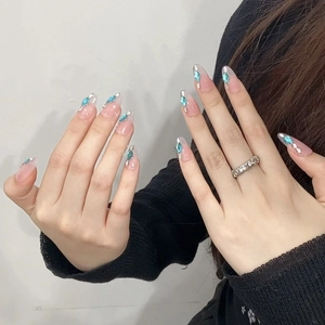 Handmade press-on nails in translucent pink with blue rhinestones and silver glitter
