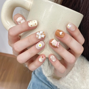 Handmade toast pig press-on nails with 3D piglet and bow designs in cream and brown