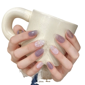 Short oval press-on nails with purple gradient, golden lines, 3D flowers and pearls