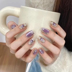 Purple cat eye press-on nails with silver metallic texture and pearl rhinestone accents