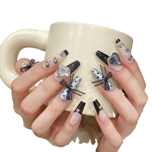 Handmade black French press-on nails with 3D bows and heart rhinestones on long coffin shape