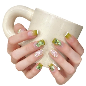 Green gradient press-on nails with handmade lemon art and 3D heart crystals