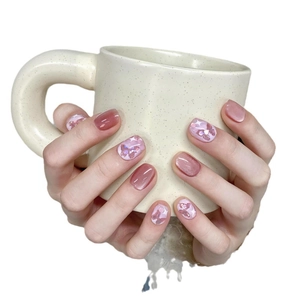 Short handmade press-on nails with aurora butterfly art and soft pink cat eye finish
