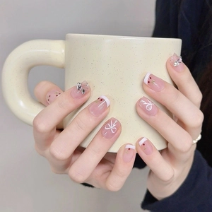 Handmade press-on nails with red cherry patterns and 3D silver bowknot accessories