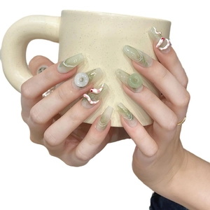Handmade press-on nails with green marble design and 3D artistic relief decorations