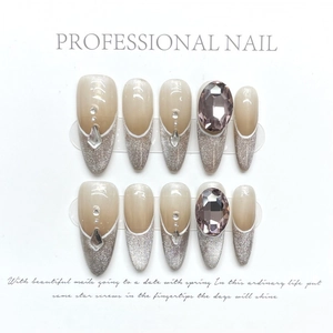 Sparkling cat-eye press-on nails with silver French tips and pink teardrop gemstone