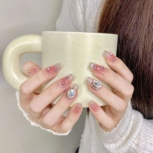 Pink gradient press-on nails with shiny rhinestones and oversized silver gems decoration