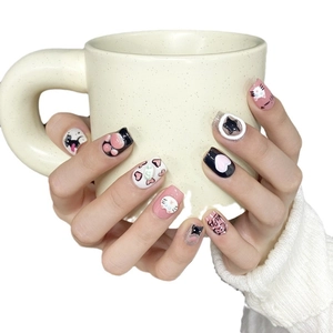 Handmade press-on nails featuring 3D pink cat paw and cute doodle designs on white background