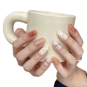 Handmade amber marble press-on nails with 3D gold accents and purple foil details