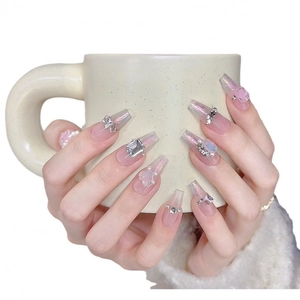 Handmade sheer pink ballerina press-on nails with 3D bows, rhinestones and pearls