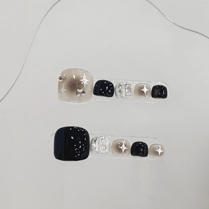 Handmade black and silver glitter press-on toenails with star patterns and rhinestones