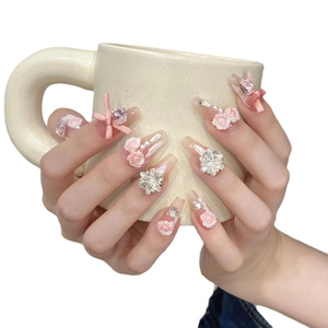 Unghie finte rosa con rose 3D, fiocchi e strass in stile lungo a ballerina
