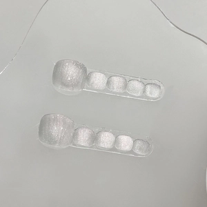 Handmade white cat-eye press-on toenails with shimmering silver and soft pink glitter finish